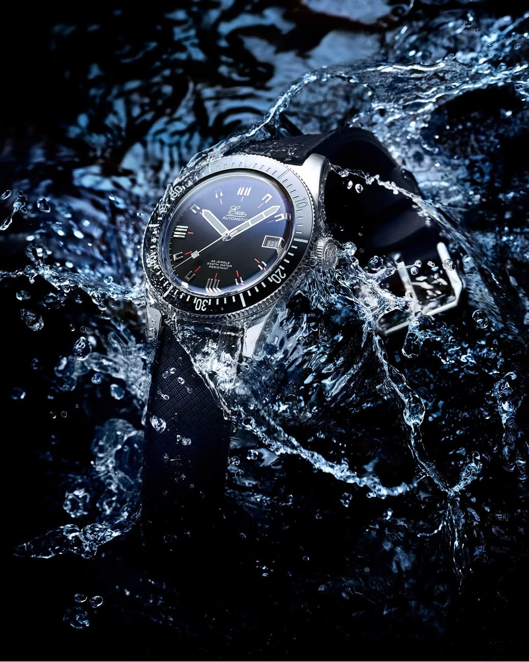 A vintage-inspired watch photographed in dramatic water splashes