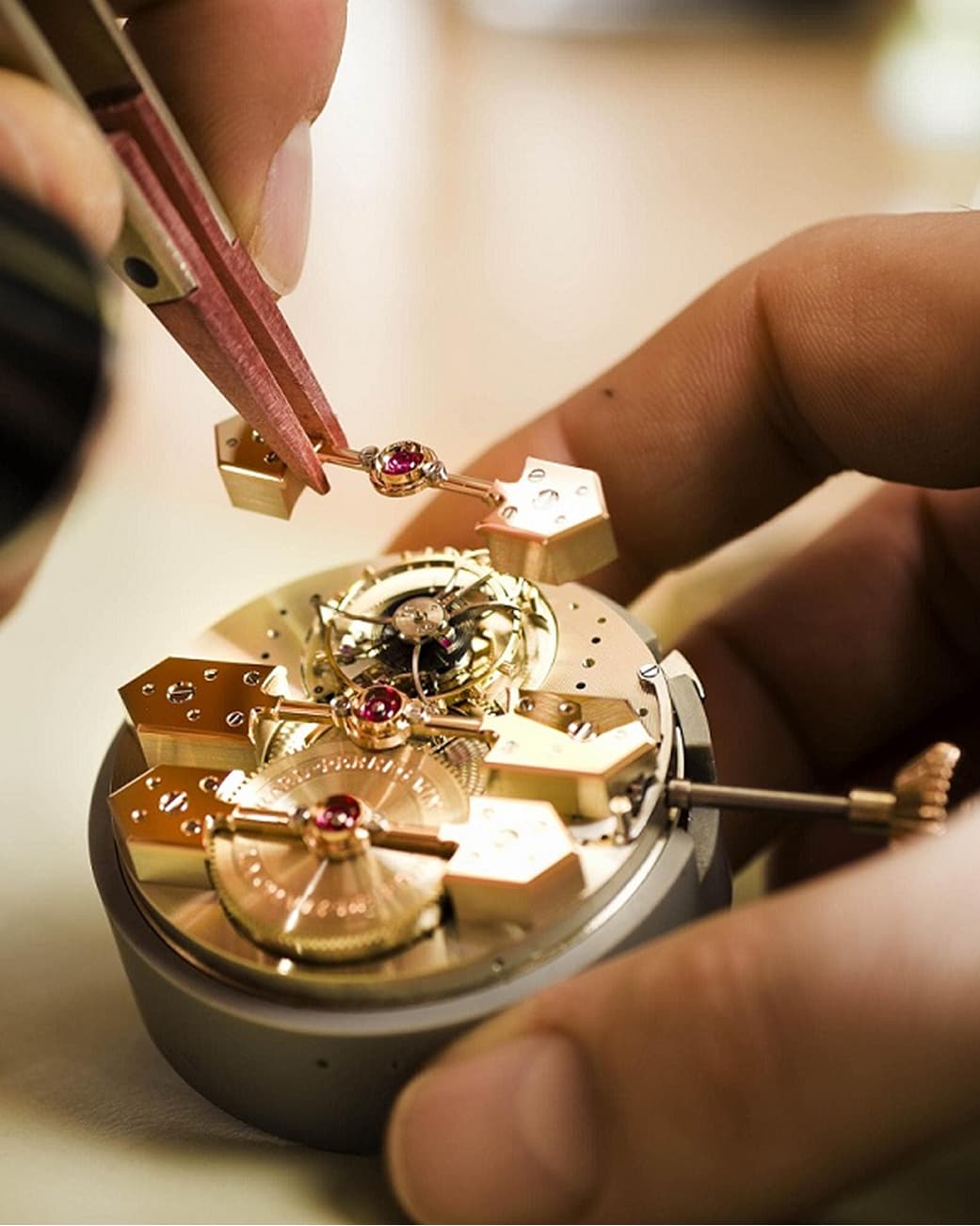 A watchmaker assembling a mechanical watch movement